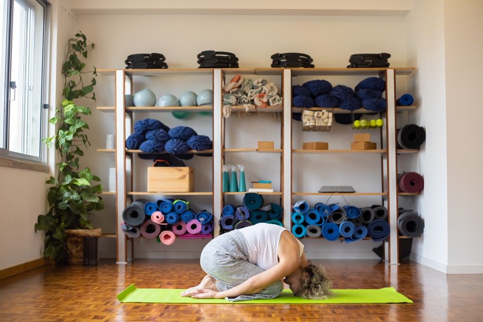 A restorative pose supported by bolsters and blankets